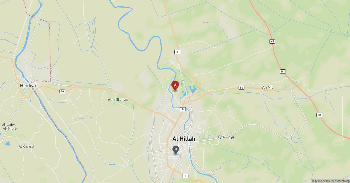 Map of central Iraq with a red pin at the ruins of Babylon and a grey marker at Hillah to the south.